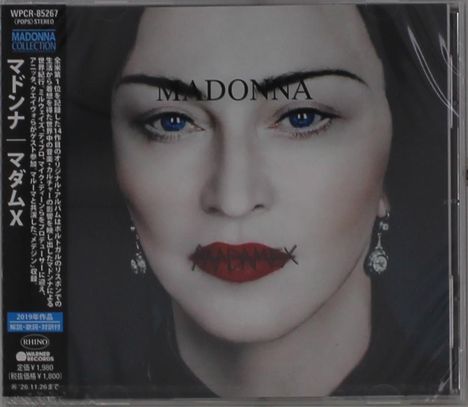 Cover mit dem Text "MADONNA" und "MADAME X". Portrait einer Frau mit roten Lippen und blauen Augen. Japanischer Text links.