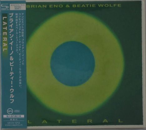 Text oben: "BRIAN ENO & BEATIE WOLFE". Links: "LATERAL". Abstrakte Illustration mit gelb-grünem Kreis auf dunklem Hintergrund.