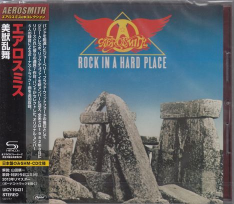 "Aerosmith: Rock in a Hard Place" mit japanischem Text links, darunter historische Steinformation.
