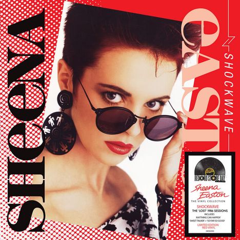 Auf rotem Hintergrund steht "SHOCKWAVE" und "SHEENA EASTON". Frau mit kurzen Haaren und Sonnenbrille im Vordergrund.