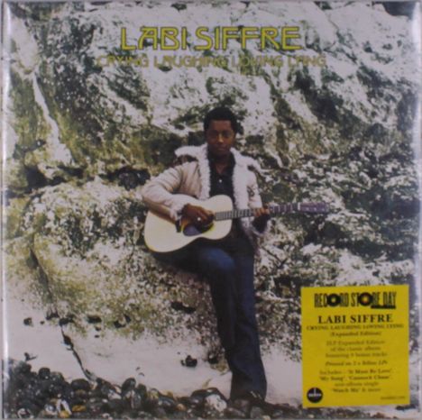 "Labi Siffre, Crying Laughing Loving Lying. Person mit Gitarre lehnt an einer Felswand, gelber Sticker mit Infos."
