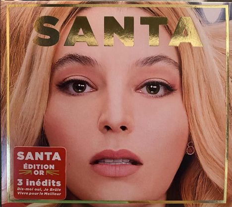 Text: "SANTA", "Édition Or", "3 inédits". Großaufnahme eines blonden Gesichts mit ausdrucksstarken Augen.