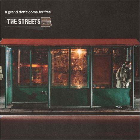 Der Text "a grand don't come for free" und "THE STREETS" steht oben. Ein Mann in einem Mantel wartet an einer Bushaltestelle.