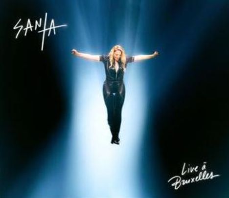 Texte: "SANIA", "Live à Bruxelles". Eine Frau steht mit ausgestreckten Armen in einem Lichtstrahl.