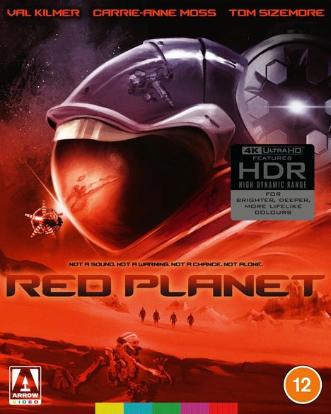 Text: "VAL KILMER CARRIE-ANNE MOSS TOM SIZEMORE", "RED PLANET", "Not a sound. Not a warning. Not a chance. Not alone." Illustration: Mars-Landschaft, Astronaut.