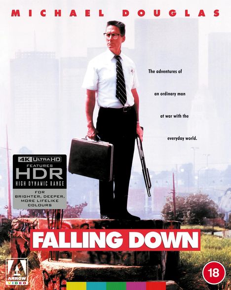"Falling Down" in weißem Text vor einem Mann mit Krawatte und Aktentasche, der entschlossen in die Ferne schaut.