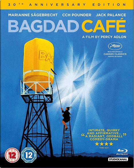 "Bagdad Café - A Film by Percy Adlon. Person auf Leiter malt gelben Wasserturm. Text: 'Intimate, quirky, and affirmative...'“