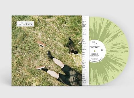 Text: "Kreftel/Bartosek - Still Here". Ein grünes Vinyl ist teilweise sichtbar. Neben dem Text liegt eine Person im Gras.