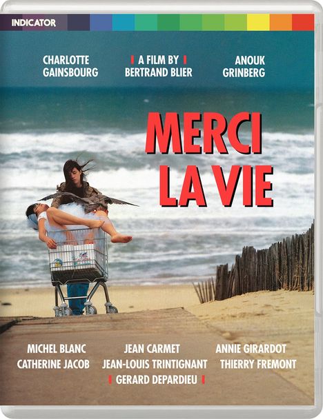 Texte: "MERCI LA VIE", "A FILM BY BERTRAND BLIER". Zwei Frauen im Einkaufswagen am Strand.
