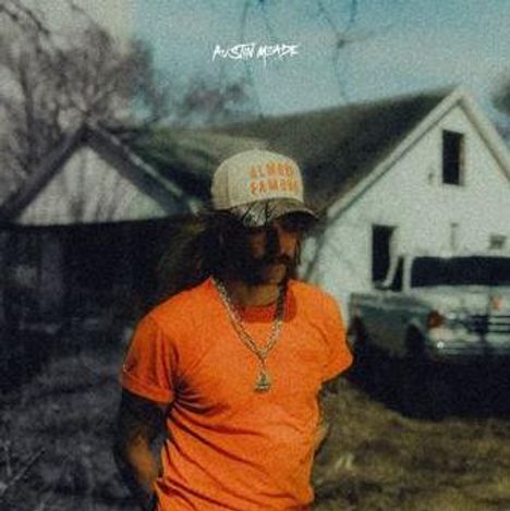 Text: "AUSTIN MEADE", "GAP GOD GUNS". Ein Mann in Orange steht vor einem rustikalen Haus und einem Truck.