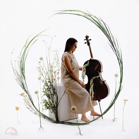 Ein halbkreisförmiges Logo links unten. Eine Frau in einem langen Kleid sitzt mit einem Cello, umgeben von Blumen.