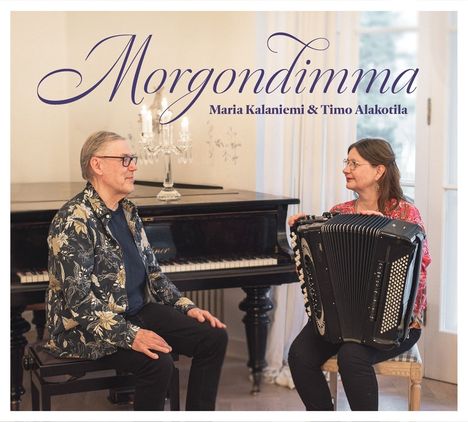 "Morgondimma" Maria Kalaniemi & Timo Alakotila. Ein Mann am Klavier und eine Frau mit Akkordeon lächeln einander an.