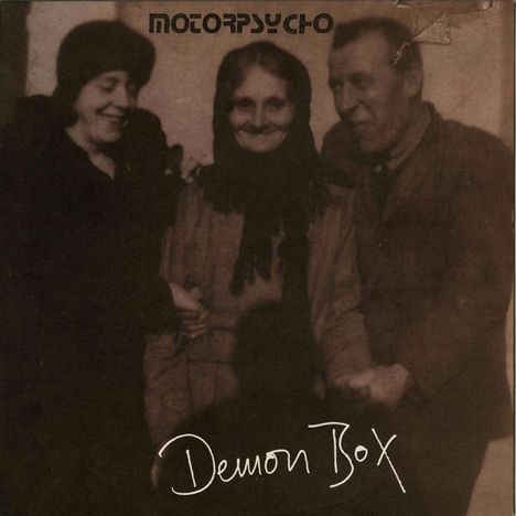 "Demon Box" und "Motorpsycho" sind sichtbar. Drei Personen in altmodischer Kleidung lächeln, arm in arm.