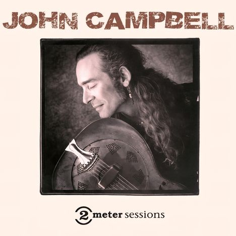 Text: "John Campbell", "2 meter sessions". Ein Mann mit langen Haaren hält eine Metallgitarre und lächelt mit geschlossenen Augen.