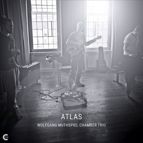 Text: "ATLAS WOLFGANG MUTHSPIEL CHAMBER TRIO". Drei Musiker, Instrumente in einem lichtdurchfluteten Raum.