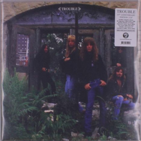 "TROUBLE", "35th Anniversary Edition". Fünf Männer mit langen Haaren stehen und sitzen vor einem alten, steinernen Torbogen.