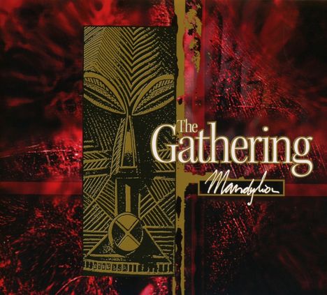 Text: "The Gathering Mandylor". Illustration mit abstraktem, maskenähnlichem Muster, rot-schwarzer Hintergrund.