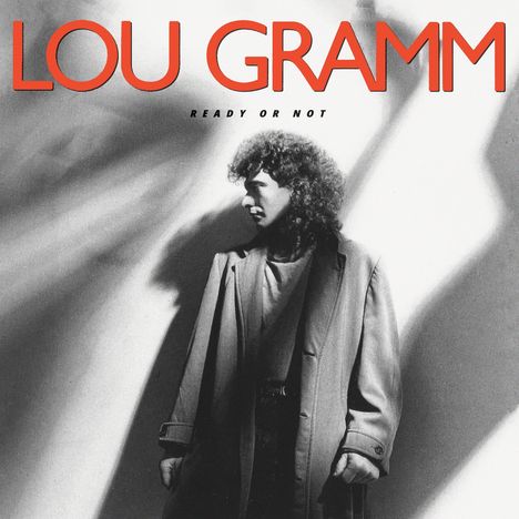 Text: "LOU GRAMM" oben, "READY OR NOT" darunter. Schwarzweißes Foto eines Mannes mit Locken und Mantel, Schatten im Hintergrund.