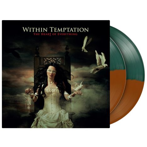 „Within Temptation: The Heart of Everything“. Frau auf Thron mit Vögeln umgeben, trägt Bandagen und hält Kette.