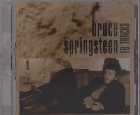 Text: "Bruce Springsteen 18 Tracks". Sepiafarbenes Cover mit einem Mann in entspannter Haltung auf einem Sofa.