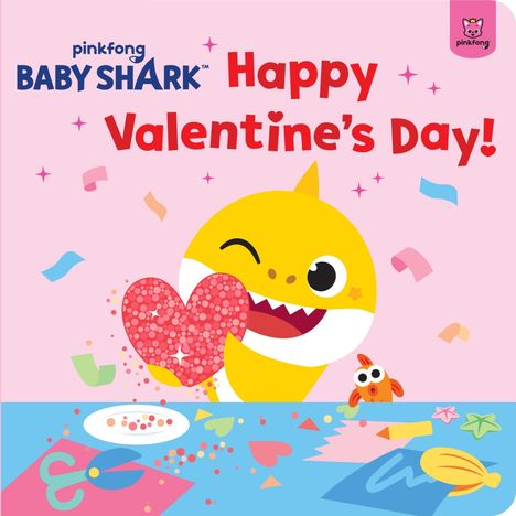 „Happy Valentine’s Day!“ Oben links Baby Shark-Logo. Gelber Hai hält glitzerndes Herz. Konfetti und Bastelmaterial auf dem Tisch.
