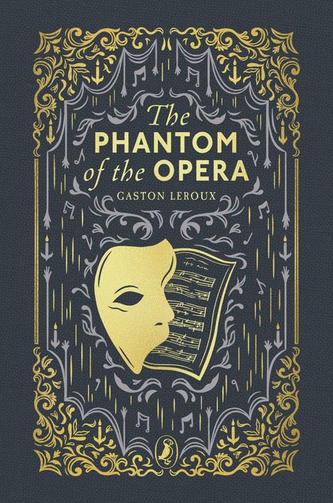 „The Phantom of the Opera“, Gaston Leroux. Vergoldete Maske, Notenblätter, dekorative Verzierungen.