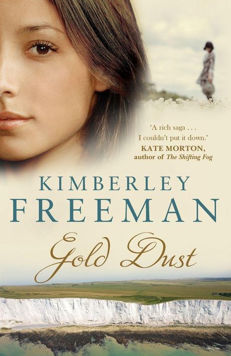 Ein Buchcover mit „Kimberley Freeman – Gold Dust“. Links ein Gesicht, rechts eine Person in der Ferne, unten Klippen.