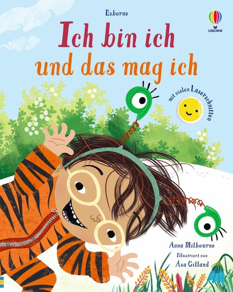 Text: "Ich bin ich und das mag ich", "mit vielen Laserschnitten", "Anna Milbourne", "Illustriert von Asa Gilland".
Illustration: Fröhliches Kind im Tigerkostüm mit Brille, grünes Monster, Blumen.