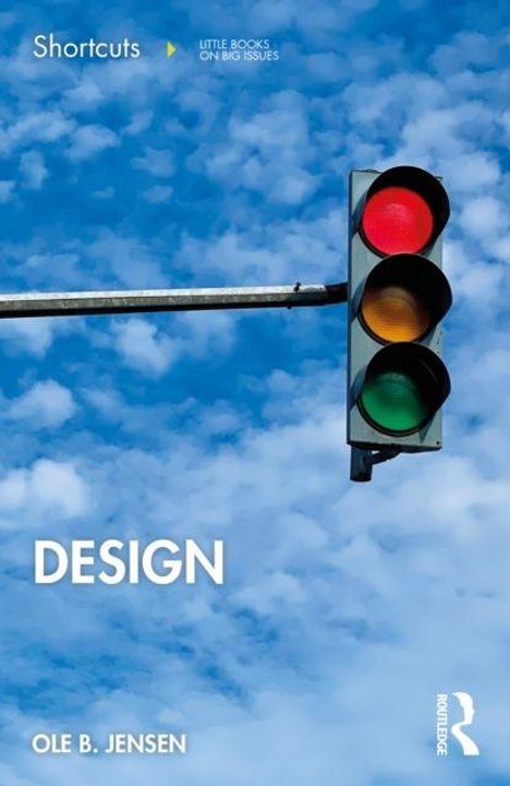 „DESIGN“ von Ole B. Jensen. Ampel mit rotem Licht vor blauem, wolkigem Himmel.