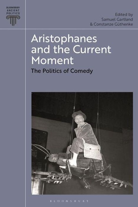 "Aristophanes and the Current Moment: The Politics of Comedy. Edited by Samuel Gartland & Constanze Güthenke." Ein Mann sitzt auf einer skurrilen Vorrichtung.