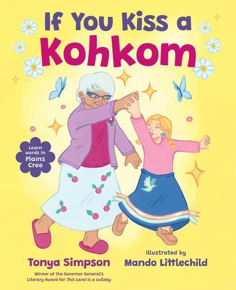Titel: "If You Kiss a Kohkom". Text: "Learn words in Plains Cree". Zwei tanzende Figuren, ältere Frau und Mädchen, umgeben von Schmetterlingen.