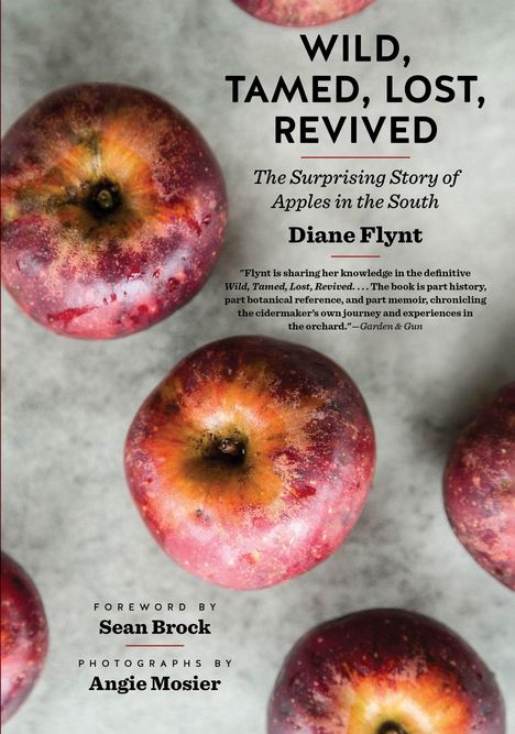 Titel: "WILD, TAMED, LOST, REVIVED" von Diane Flynt. Abgebildet sind rote Äpfel auf einer hellen Oberfläche.