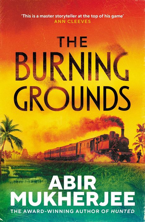 Text in der Mitte: "THE BURNING GROUNDS". Unten: "ABIR MUKHERJEE". Dampflokomotive fährt durch tropische Landschaft.