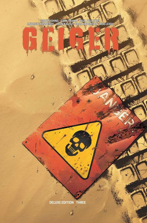 Texte: „GEIGER“, „DANGER“, „DELUXE EDITION THREE“. Warnschild mit Totenkopf auf staubiger Fläche.