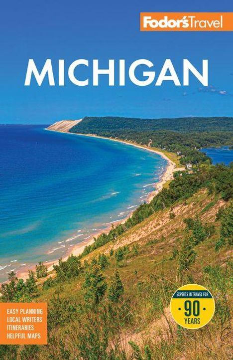 "MICHIGAN" oben, darunter Küstenlandschaft mit blauem Wasser, Sanddünen und Wald. Logo oben rechts: Fodor's Travel.