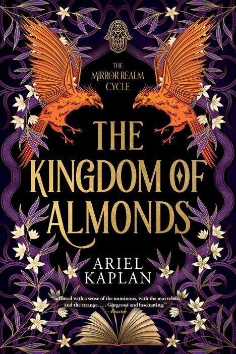 "Cover to be revealed soon!" in blauer Schrift oben rechts. Titel: "THE KINGDOM OF ALMONDS by Ariel Kaplan" auf schwarzem Hintergrund mit kleinem blauem Logo unten.