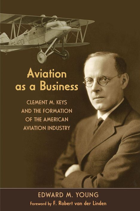 „Aviation as a Business“, darunter ein Zweiflugzeug und ein Mann mit Brille in einem Anzug.