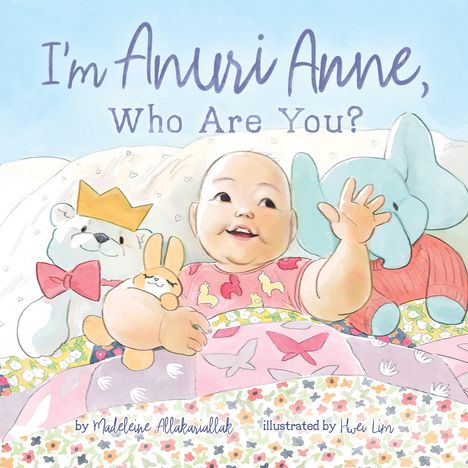 Text: "I'm Anuri Anne, Who Are You?"
Illustration: Lächelndes Baby, umgeben von Plüschtieren, bunter Decke.