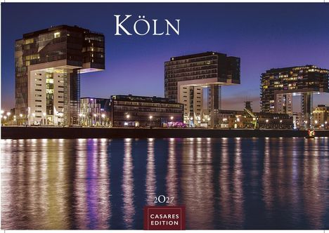 „Köln 2027 Casares Edition“: Nachtansicht der Kranhäuser am Wasser mit reflektierendem Licht.