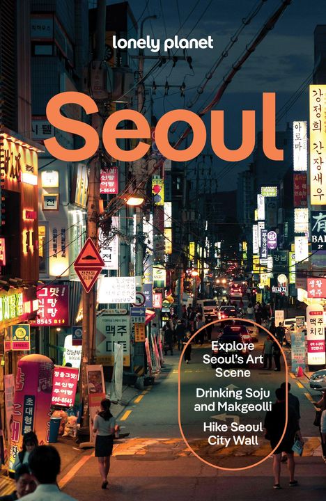 Oben steht "lonely planet", darunter groß "Seoul". Eine belebte nächtliche Straßenszene mit vielen Neonlichtern.