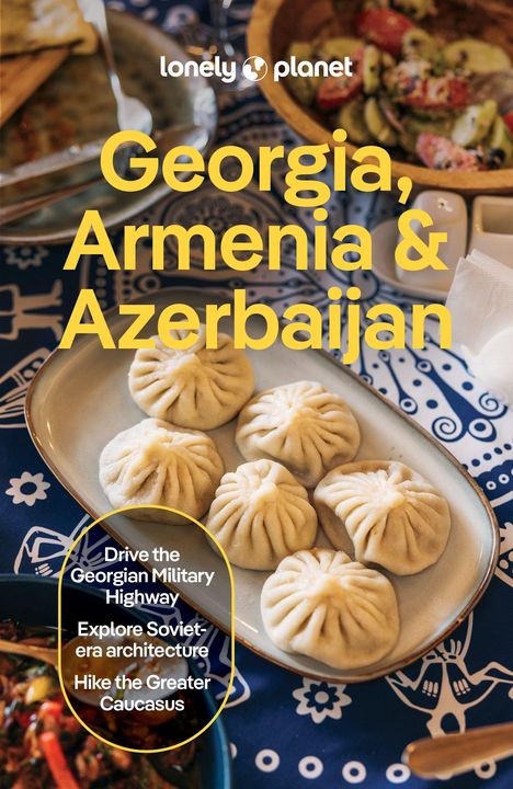 Text: "Georgia, Armenia & Azerbaijan. Drive the Georgian Military Highway. Explore Soviet-era architecture. Hike the Greater Caucasus." Einrichtungstisch mit gefüllten Teigtaschen und Salat.