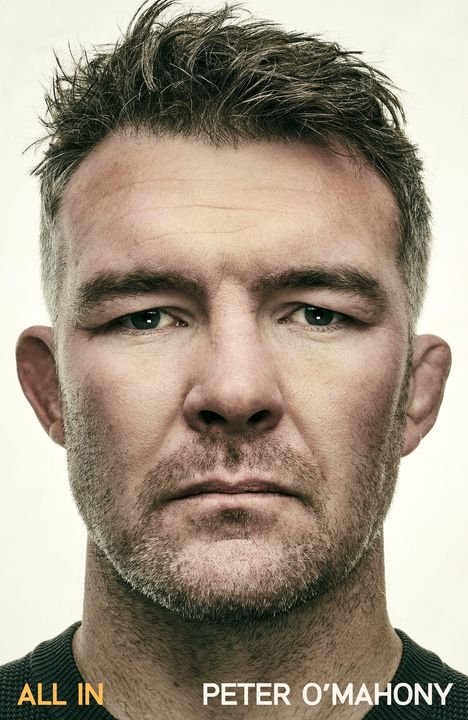 Text: "ALL IN" und "PETER O'MAHONY". Nahaufnahme eines Mannes mit entschlossenem Blick und Bart.