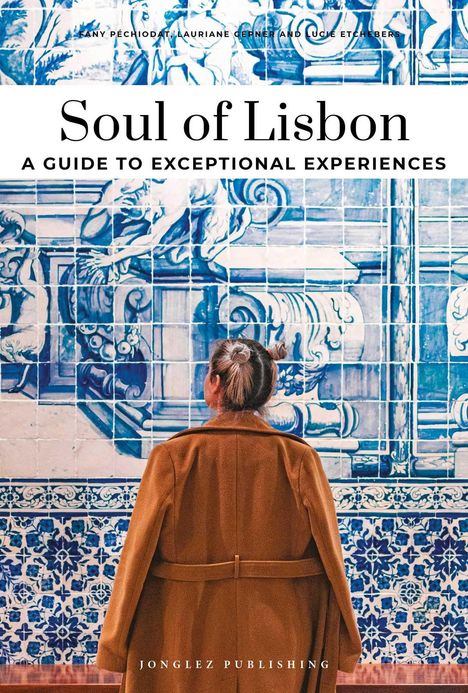 "Soul of Lisbon: A Guide to Exceptional Experiences." Eine Frau mit braunem Mantel betrachtet blaue Fliesenmuster.
