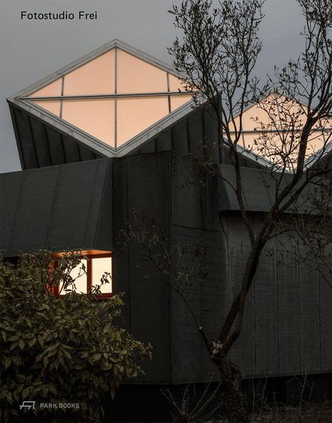 "Fotostudio Frei" steht oben links. Architektur mit beleuchteten, diamantförmigen Fenstern, Bäume im Vordergrund.