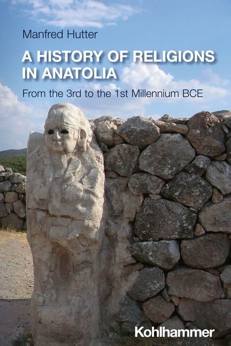 Titel: "A History of Religions in Anatolia". Steinskulptur vor Felswand unter blauem Himmel.