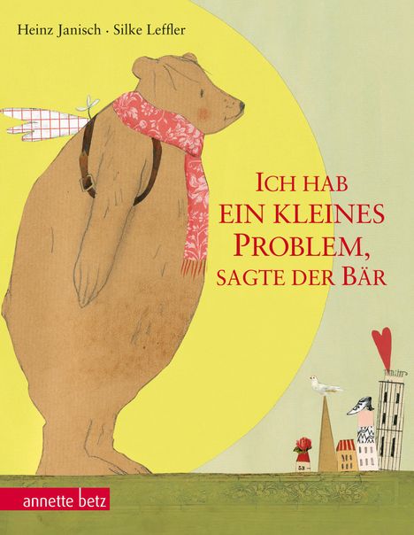Ein Bär mit Schal steht vor gelbem Kreis; daneben kleine Häuser, Vogel und Rose unter Herz; Text: "Ich hab ein kleines Problem, sagte der Bär".