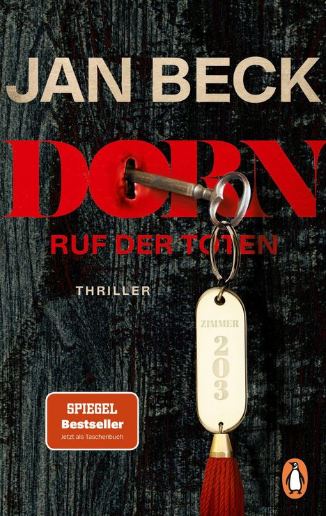 "JAN BECK DORNRUF DER TOTEN THRILLER. Schlüssel mit Anhänger 'Zimmer 203' in einem Schlüsselloch, rote Quaste."