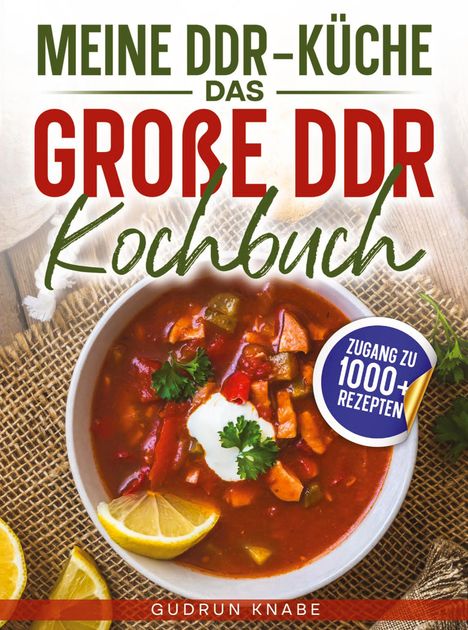 Text: "MEINE DDR-KÜCHE DAS GROßE DDR Kochbuch. Zugang zu 1000+ Rezepten. Gudrun Knabe."  
Bild zeigt einen Eintopf mit Zitrone.