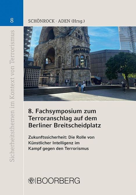 8. Fachsymposium zum Terroranschlag auf dem Berliner Breitscheidplatz. Gebäude mit zerstörtem Turm, sonniger Tag.
