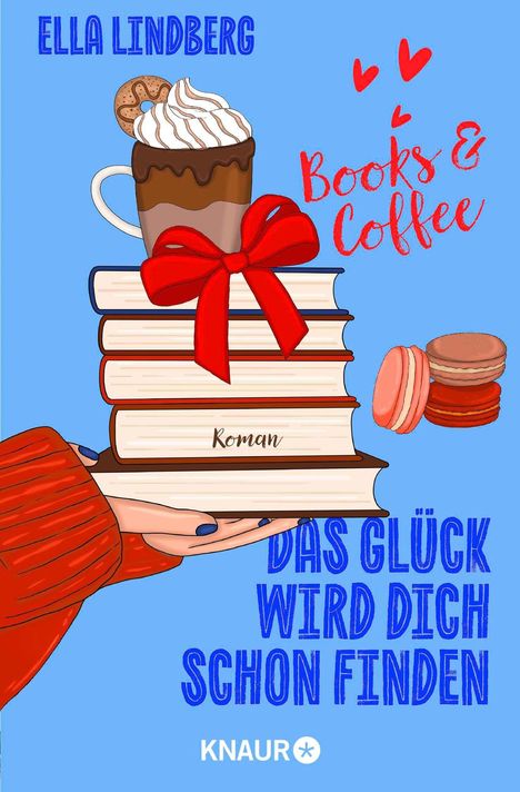 „Ella Lindberg. Books & Coffee. Roman. Das Glück wird dich schon finden.“ Illustration mit Büchern, Tasse und Macarons.